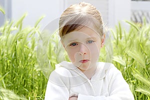 Angry disappointed gesture little girl meadow