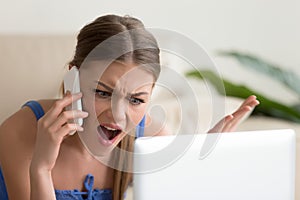 Angry dissatisfied young woman calling customer support, arguing