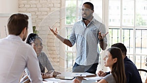 Angry diverse colleagues dispute at company office meeting