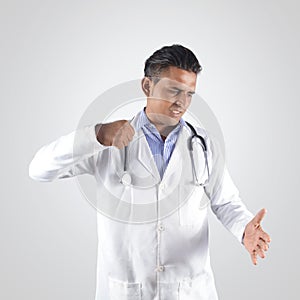 Angry doctor hiting hand with tension