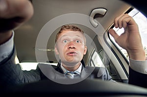 Angry driver behind the wheel of a car while driving