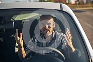 Angry driver drives a car in the city.