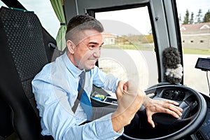 Angry driver showing fist and driving bus