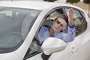 Angry driver stuck at traffic jam watching outside car