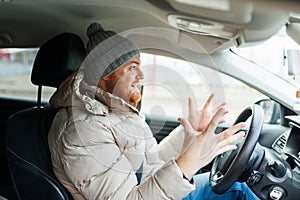 Angry driver in a traffic jam. He screams and gesticulates,