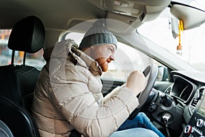 Angry driver in a traffic jam. He screams and gesticulates,