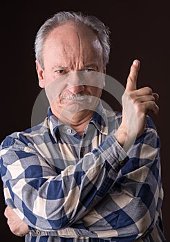 Angry elderly man pointing up