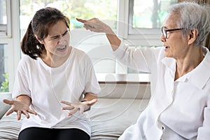 Angry elderly people has quarrel violently with aggressive woman at home,annoyed senior mother pointing finger to daughter,arguing