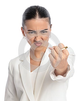 angry elegant businesswoman in white suit showing fist and punching