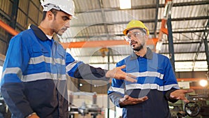 Angry engineer boss scolding young engineers for their mistake standing in the CNC manufacturing factory. Negative boss yelling