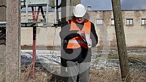 Angry Engineer with documentation near powerline