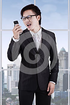 Angry entrepreneur yelling on his phone