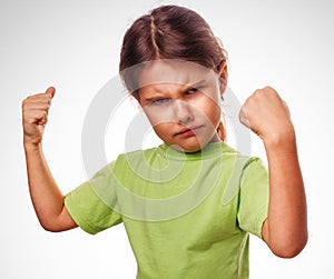 Angry evil girl shows fists experiencing anger and