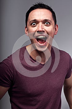 Angry excited man shouting the wide opened mouth. Closeup emotion