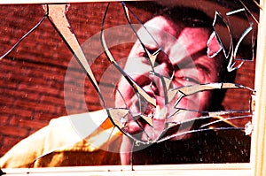 Angry face in broken glass