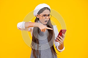 Angry face, upset emotions of teenager girl. Mobile online shopping. Funny teen child girl paying with phone, texting