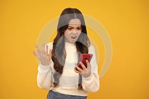 Angry face, upset emotions of teenager girl. Teenager child using mobile phone, chatting on web. Mobile app for