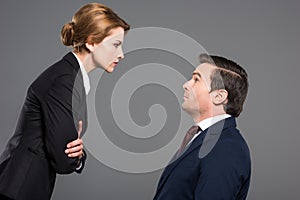 angry female boss looking at scared businessman