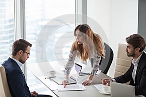 Angry female client pointing at mistake in business document