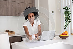 Angry female freelancer crumpling paper while working from home