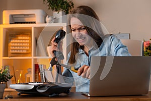 Angry female manager smashes the phone with a hammer. Business and working moments concept