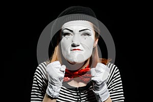 Angry female mime on black, close view. Woman is mad of somebody
