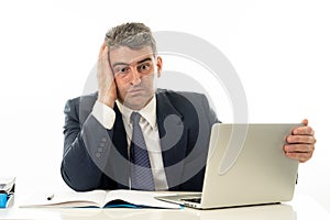 Angry and frustrated businessman with laptop shouting and worrying