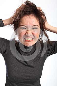 Angry and frustrated woman pulls her hair out