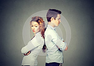Angry frustrated young couple standing back to back