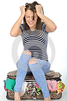 Angry Frustrated Young Woman Sitting on a Suitcase Pulling Her Hair