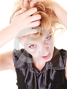 Angry furious woman pulling her messy hair