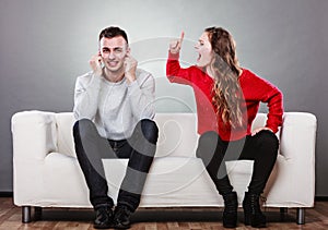 Angry fury woman screaming man closes his ears.