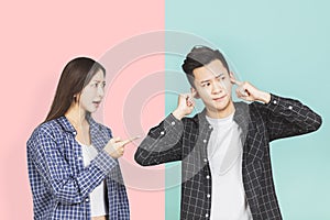 Angry fury woman screaming and man cover  his ears photo