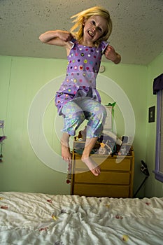 Angry girl jumping on a bed