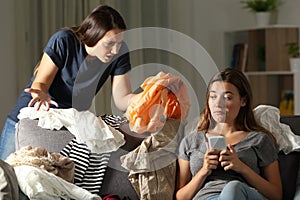 Angry girl scolding her messy roommate