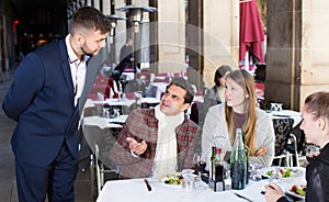 Angry guests with manager in restaurant