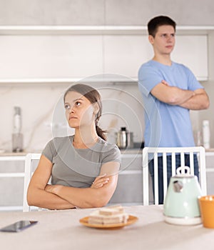 Angry guy swears at young girl, family quarrel. photo