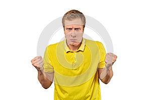 Angry guy in yellow Polo T-shirt spread his hands and yelling isolated on white background