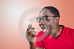 Angry handsome young man shouting while on phone
