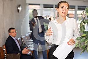 Angry hot-tempered boss shouts yells at hired employee girl in office reception.