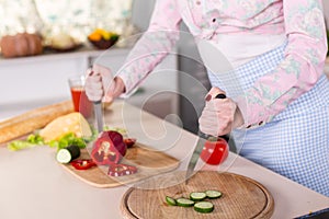 Angry housewife on kitchen with two knifes