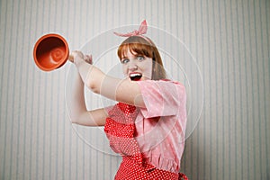 Angry housewife with plunger photo