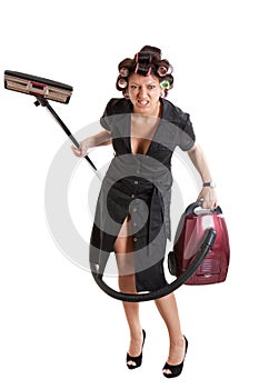 Angry housewife with a vacuum cleaner photo