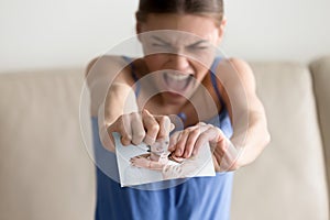 Angry hysterical woman tearing photo of happy couple, breaking u