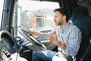 Angry indian truck driver shouting in his vehicle.