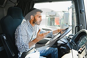 Angry indian truck driver shouting in his vehicle.