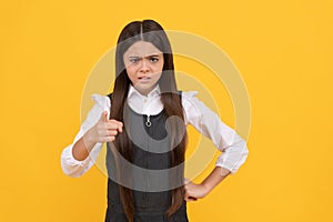 Angry kid in school uniform point accusing finger yellow background, accuse