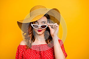 Angry lady look window dislike rainy weather wear red dress sun specs and hat isolated yellow background