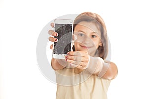 Angry little girl holding an phone with broken screen