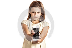 Angry little girl holding an phone with broken screen